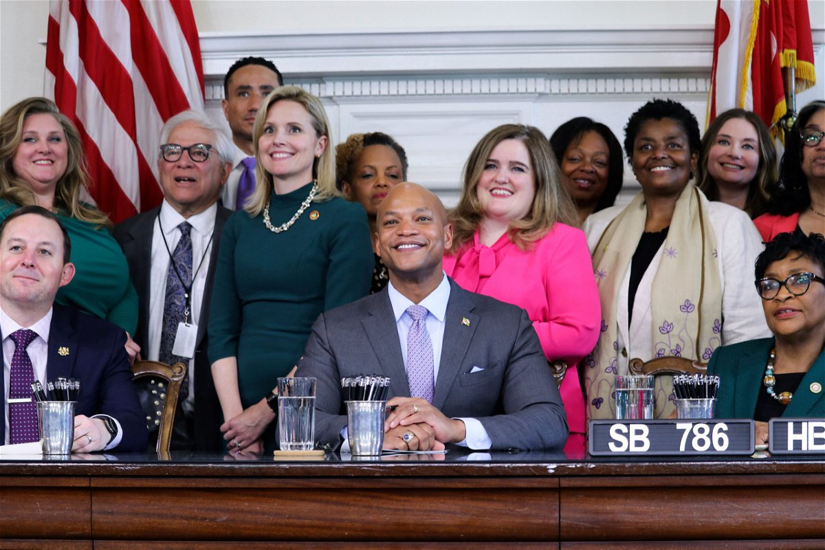 <i>Brian Witte/AP</i><br/>Maryland Gov. Wes Moore and state lawmakers pose for photos at a bill-signing ceremony on May 3 in Annapolis. Moore signed bills into law Wednesday that enshrine abortion rights and protect gender-affirming care.