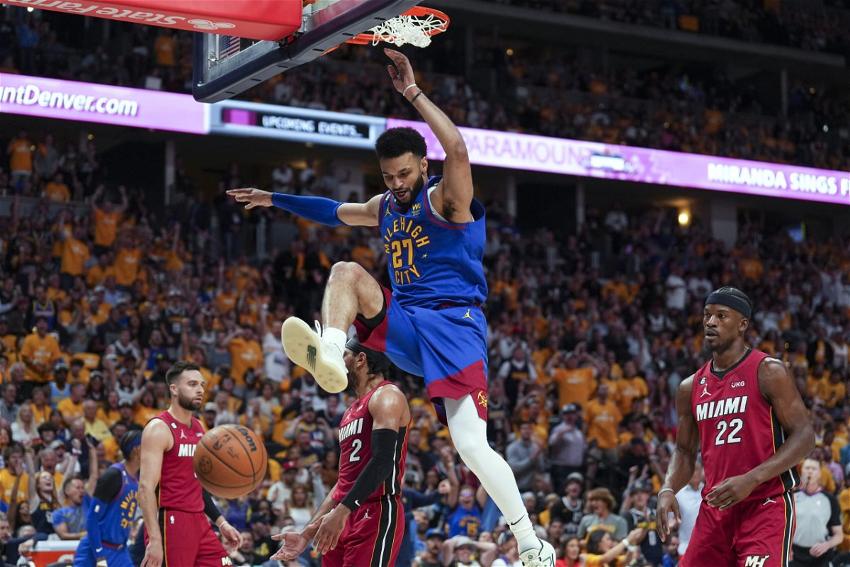 Denver Nuggets guard Jamal Murray, center, dunks against the Miami Heat during the first half of Game 1 of basketball's NBA Finals, Thursday, June 1, 2023, in Denver. 