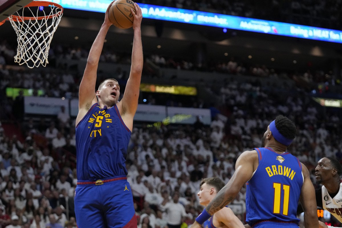 Denver Nuggets center Nikola Jokic (15) grabs a rebound during the second half of Game 3 of the NBA Finals basketball game against the Miami Heat, Wednesday, June 7, 2023, in Miami. 