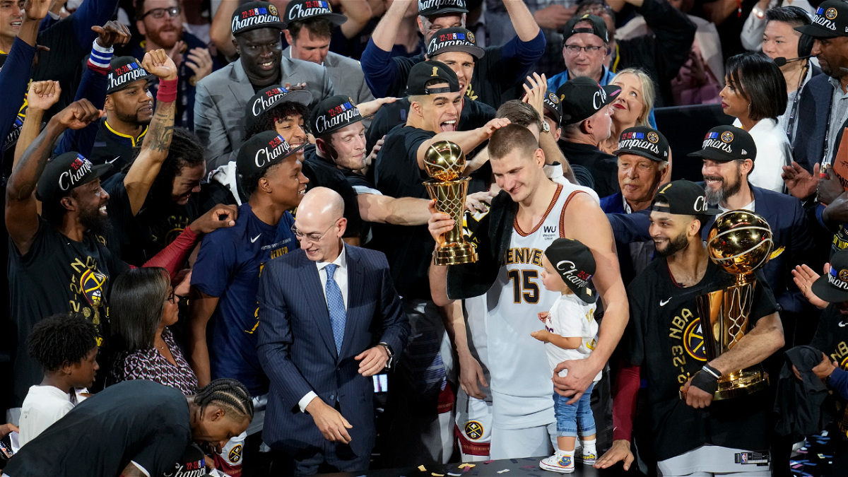 Denver Nuggets center Nikola Jokic, center, holds up the MVP award after the team won the NBA Championship with a victory over the Miami Heat in Game 5 of basketball's NBA Finals, Monday, June 12, 2023, in Denver


