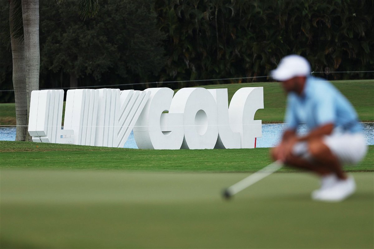 <i>Patrick Smith/LIV Golf/Getty Images</i><br/>Signage is seen as Charl Schwartzel of Stinger GC lines up a putt on the fourth green during the team championship stroke-play round of the LIV Golf Invitational - Miami at Trump National Doral Miami on October 30