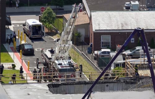 Firefighters rescue a worker after the partial collapse of a building under construction on June 2 in New Haven.