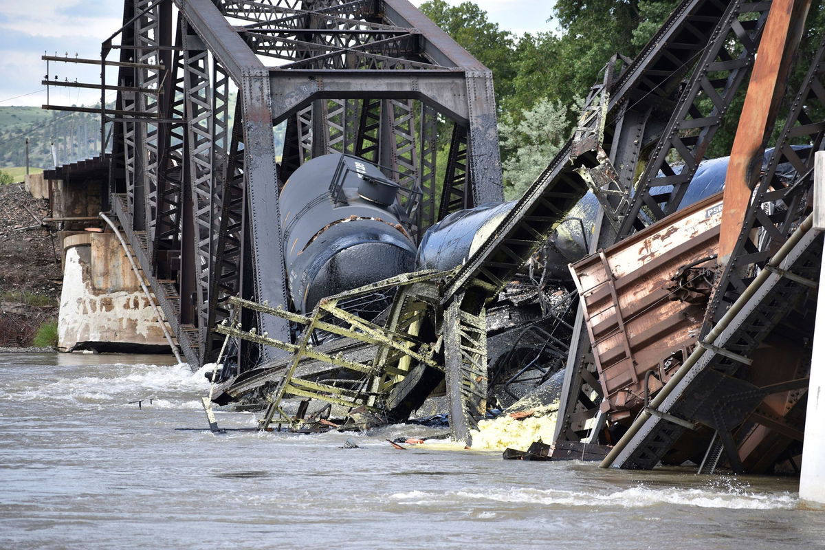 <i>Matthew Brown/AP</i><br/>Several train cars are immersed in the Yellowstone River after a bridge collapse near Columbus