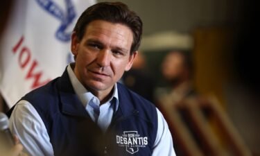 Republican presidential candidate Florida Governor Ron DeSantis listens a his wife Casey speaks during a campaign rally at Port Neal Welding Company on May 31