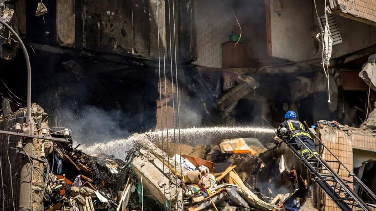 A firefighter is seen working on one of the damaged buildings on Monday.
