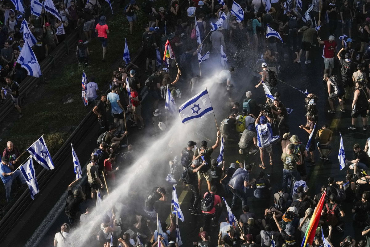 <i>Amir Cohen/Reuters</i><br/>Protesters shout slogans following a parliament vote on a contested bill that limits Supreme Court powers