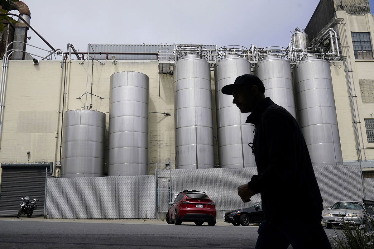 <i>Jeff Chiu/AP</i><br/>A person walks across the street from Anchor Brewing Co. in San Francisco.