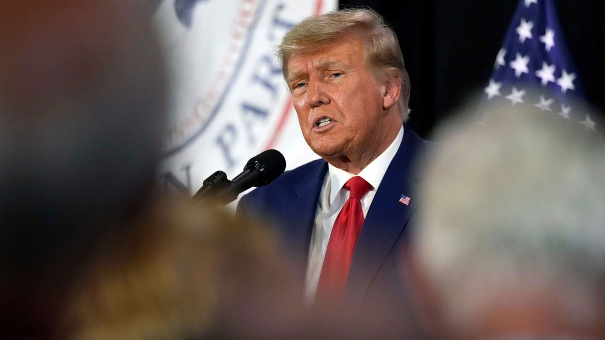 <i>Charlie Neibergall/AP</i><br/>Former President Donald Trump visits with campaign volunteers at the Elks Lodge in Cedar Rapids