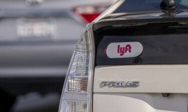 Lyft signage is pictured on a vehicle as it exits the ride-sharing pickup at San Francisco International Airport on February 3