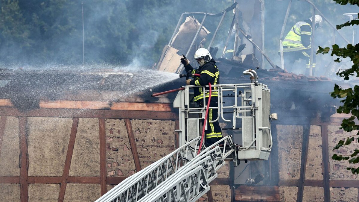 <i>Sebastien Bozon/AFP/Getty Images</i><br/>A firefighter sprays water after a fire erupted at a home for disabled people in Wintzenheim near Colmar