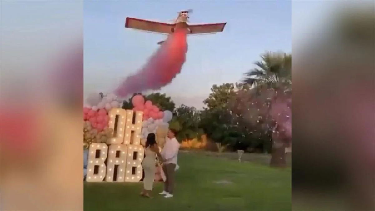 A video posted online showed the plane releasing pink smoke before crashing.
