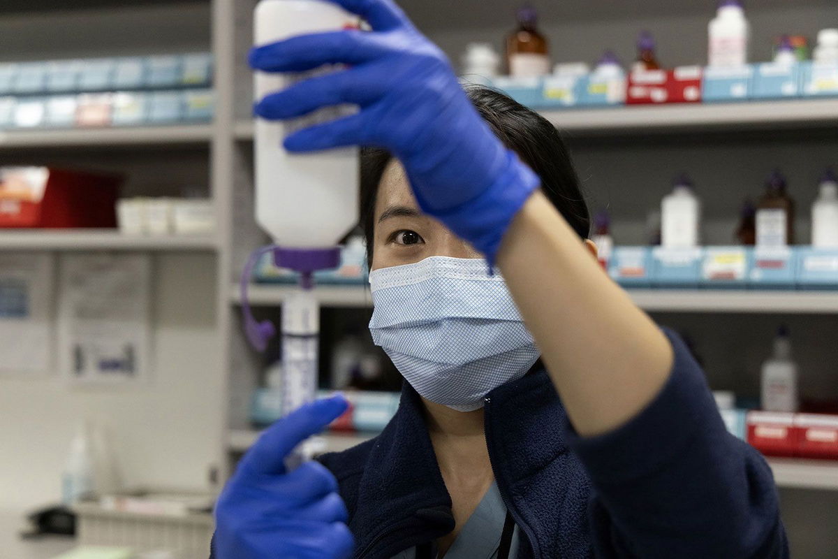 Pharmacist Selena Ko reconstitutes powered antibiotic amoxicillin and measures doses for pediatric patients at Rush University Medical Center in Chicago.