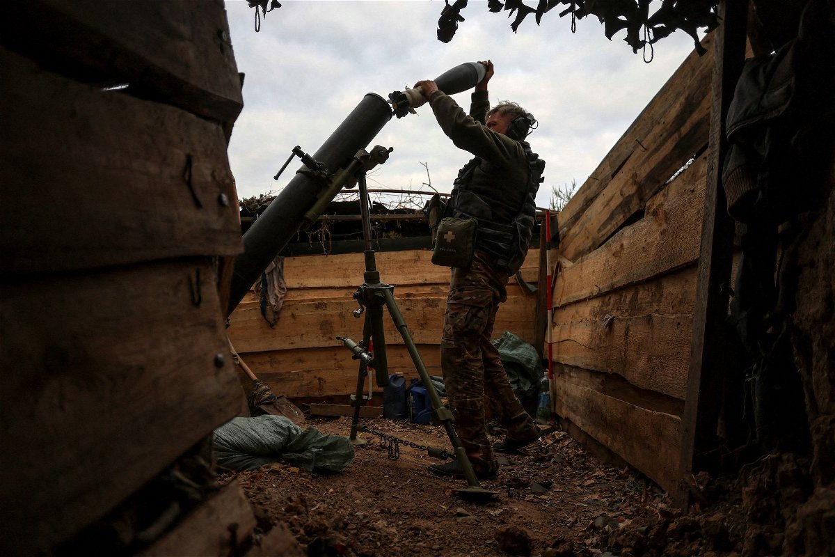 <i>Oleksandr Ratushniak/Reuters</i><br/>A Ukrainian soldier loads a shell into a mortar as he fires toward Russian troops at a position near a frontline