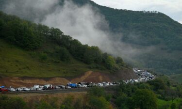 Vehicles carrying refugees from Nagorno-Karabakh head toward the Armenian border on September 25