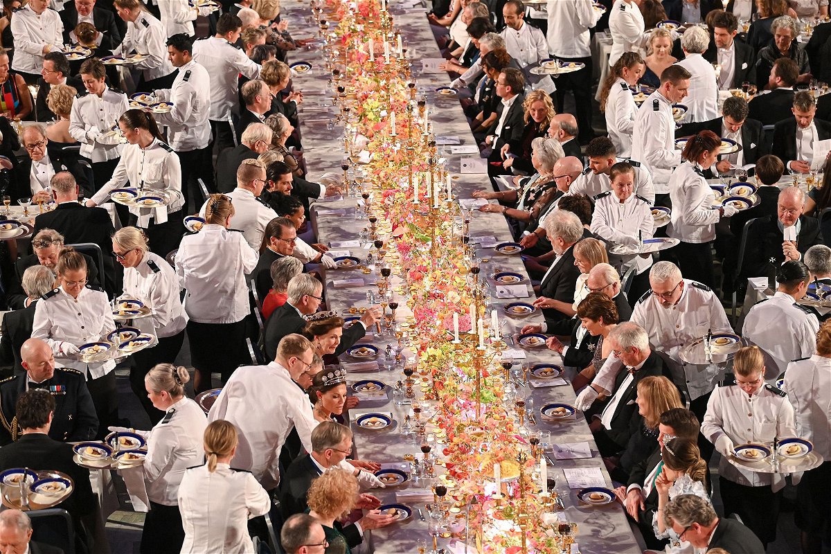 <i>Jonathan Nackstrand/AFP/Getty Images</i><br/>Waiters serve dessert during the Nobel Prize banquet on December 10