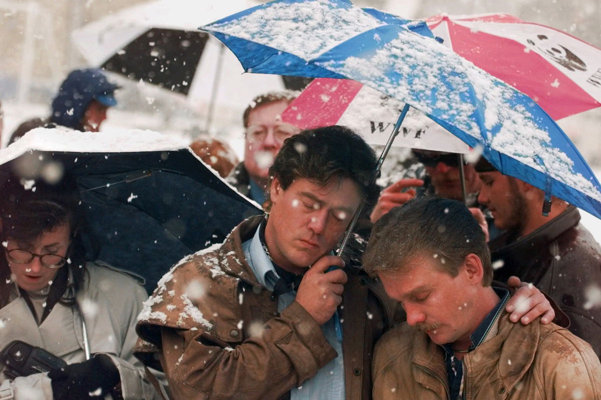 FILE - Brian Harrington, right, and Chuck Beauchine pray with other mourners during the funeral of Matthew Shepard at St. Mark's Episcopal Church Friday, Oct. 16, 1998, in Casper, Wyo. Shepard, an openly gay University of Wyoming student, died Monday from a beating in Laramie, Wyoming that's widely considered to have been at least in part motivated by his sexual orientation. 