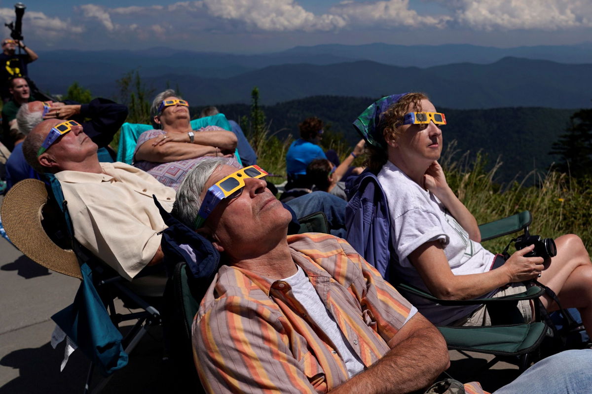 <i>Jonathan Ernst/Reuters</i><br/>People watch as the 2017 solar eclipse approaches totality from Clingmans Dome in the Great Smoky Mountains National Park