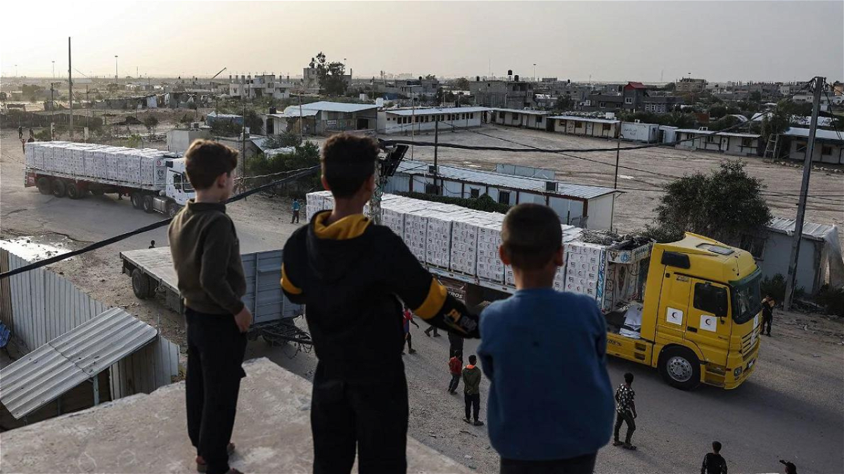 Young boys look at humanitarian aid trucks entering Gaza on November 26.
