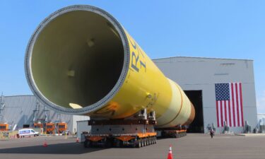 Part of a foundation for an offshore wind turbine rests on rollers outside a manufacturing facility in Paulsboro