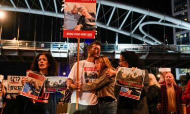 Families and friends of hostages held by Hamas in Gaza hold signs calling for their release during a demonstration in Tel Aviv