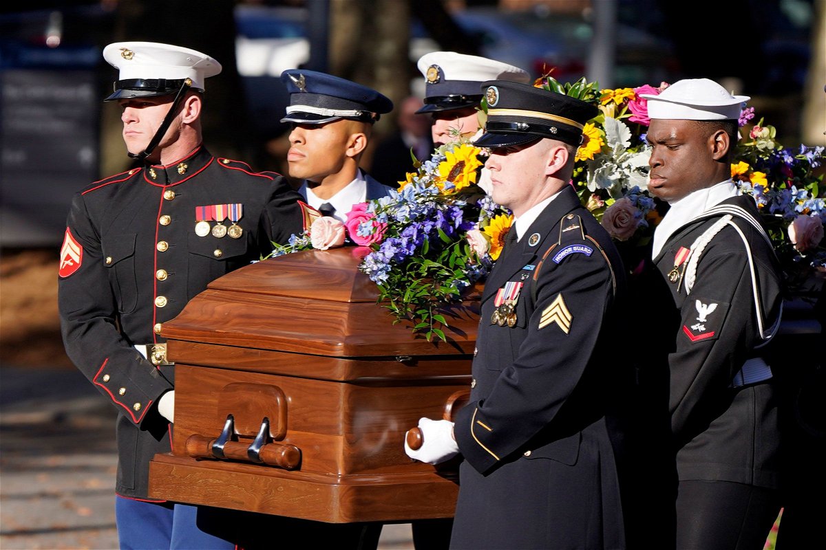 <i>Mike Stewart/Pool/AP</i><br/>A military team carries the casket of former first lady Rosalynn Carter upon arrival at the Jimmy Carter Presidential Library and Museum