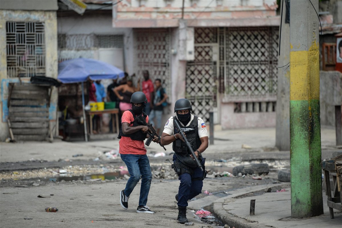 <i>Richard Pierrin/AFP/Getty Images</i><br/>Police officers patrol a neighborhood amid gang-related violence in downtown Port-au-Prince on April 25.