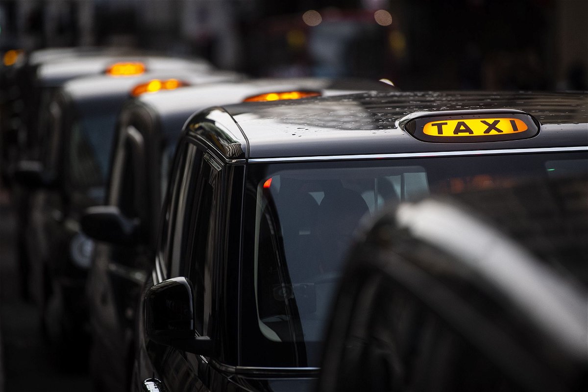 <i>Victoria Jones/PA Images/Getty Images</i><br/>A queue of black cabs outside Victoria Station in London in November 2020. Once bitter rivals fighting for control of London’s streets