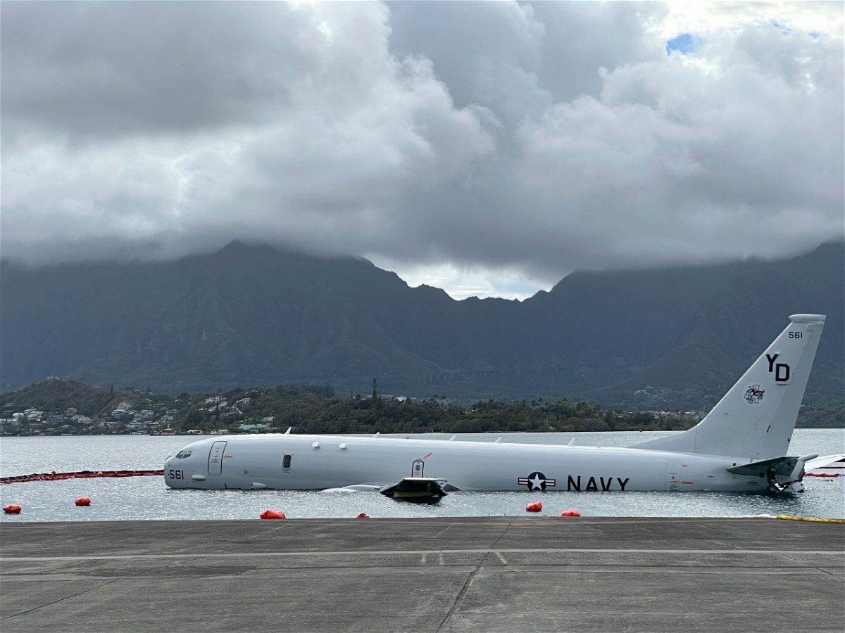 <i>Audrey McAvoy/AP</i><br/>A Navy P-8A plane that overshot a runway at Marine Corps Base Hawaii and landed in shallow water offshore sits on a reef and sand in Kaneohe Bay