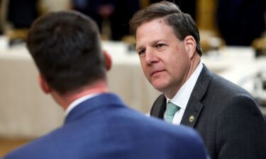 New Hampshire Governor Chris Sununu  waits for the start of a meeting between U.S. President Joe Biden and governors visiting from states around the country in the East Room of the White House on February 10