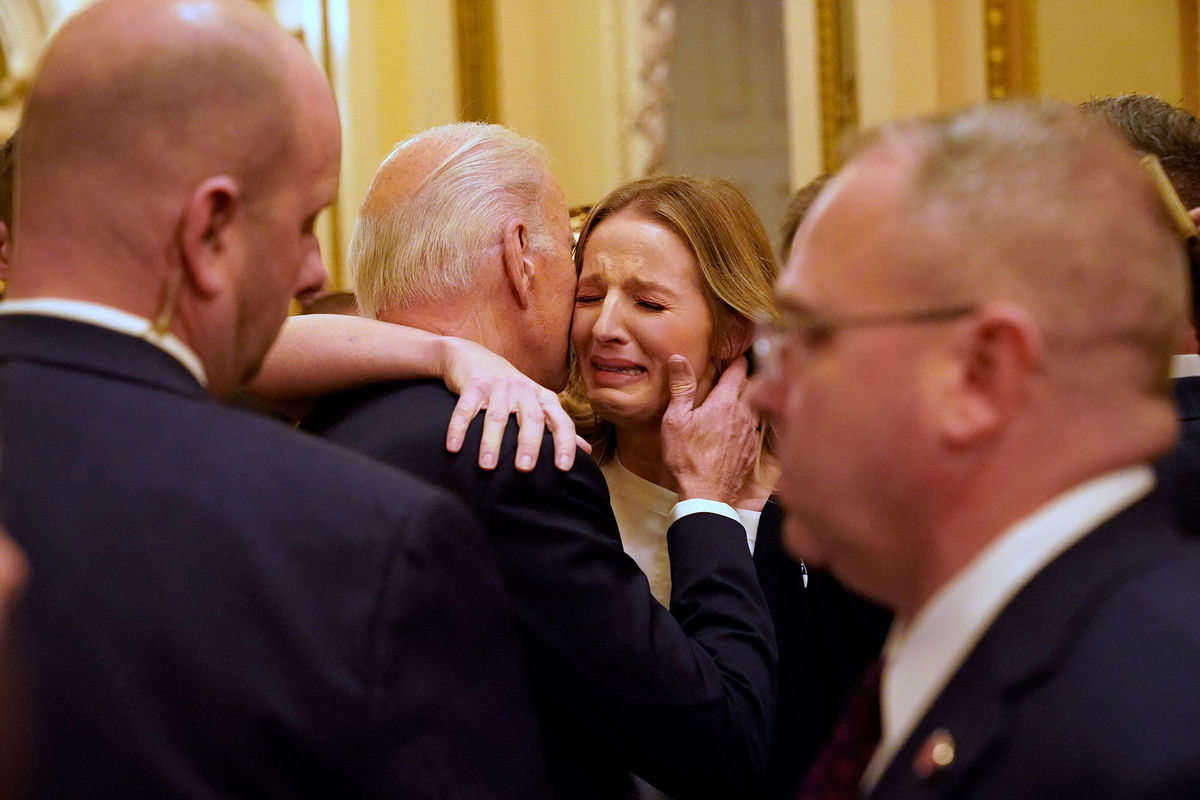 <i>Jacquelyn Martin/Pool/AFP/Getty Images/File</i><br/>President Joe Biden hugs Brittany Alkonis