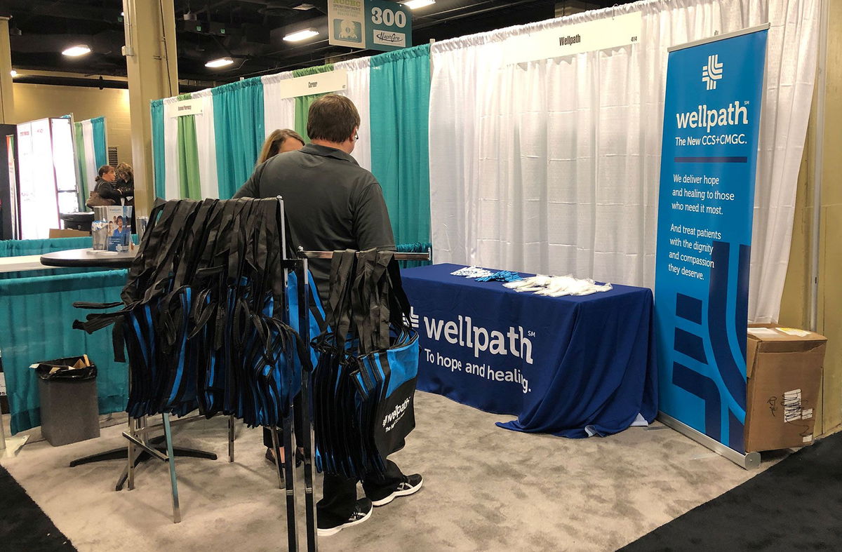 <i>Peter Eisler/Reuters</i><br/>A group of lawmakers are raising the alarm about Wellpath – the nation’s largest prison health care provider. Pictured is a Wellpath display in Nashville in 2019.