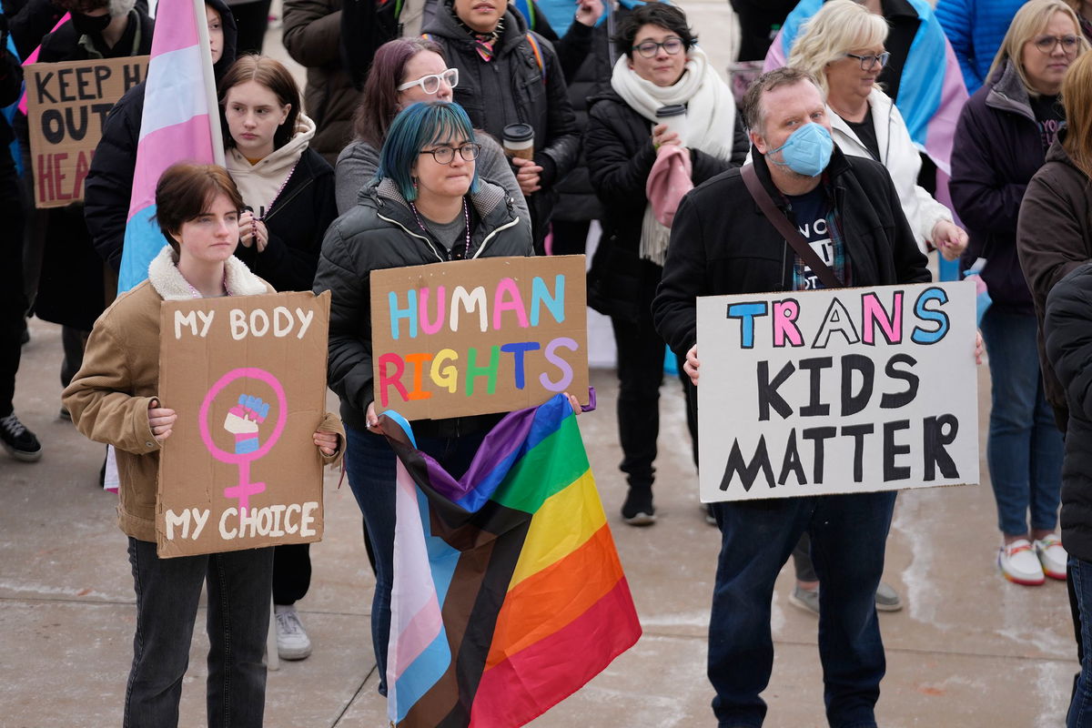 <i>Rick Bowmer/AP/FILE</i><br />People gather in support of transgender youth during a rally at the Utah State Capitol Tuesday