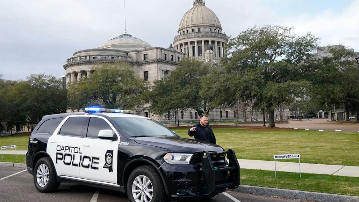 A Capitol Police officer warns off passersby as they respond to a bomb threat at the Mississippi State Capitol in Jackson on Wednesday morning.