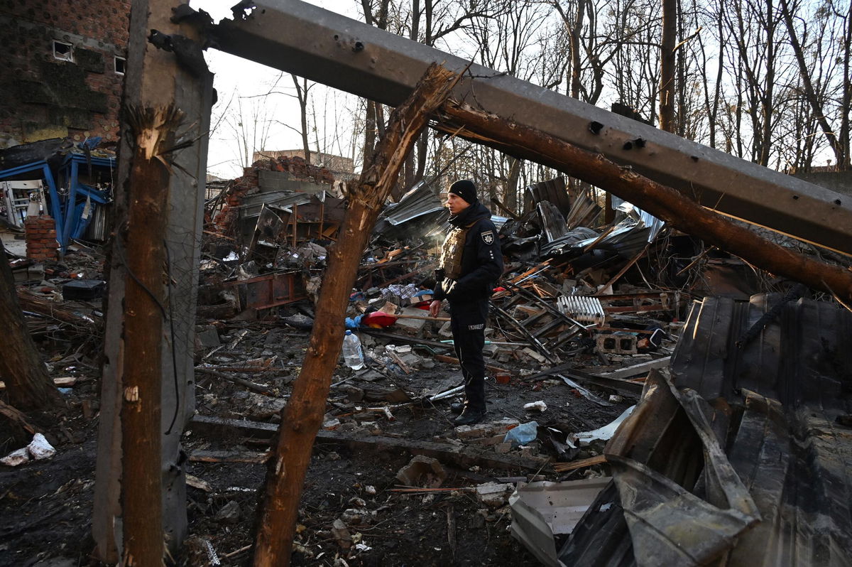 <i>Sergey Bobok/AFP/Getty Images</i><br/>Damage is seen outside an apartment building in Kharkiv on December 31 after overnight Russian drone attacks.