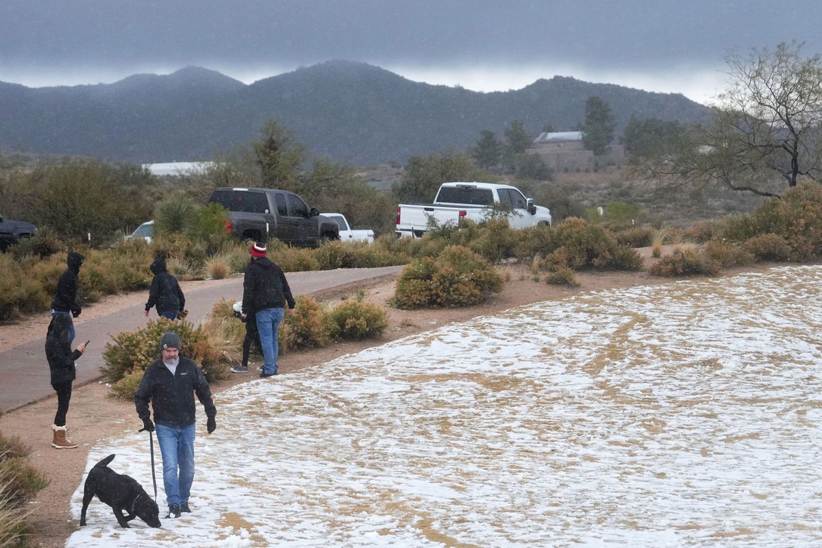 Snow and hail accumulate on the ground in Scottsdale, Arizona, as a winter storm blows through on Sunday.