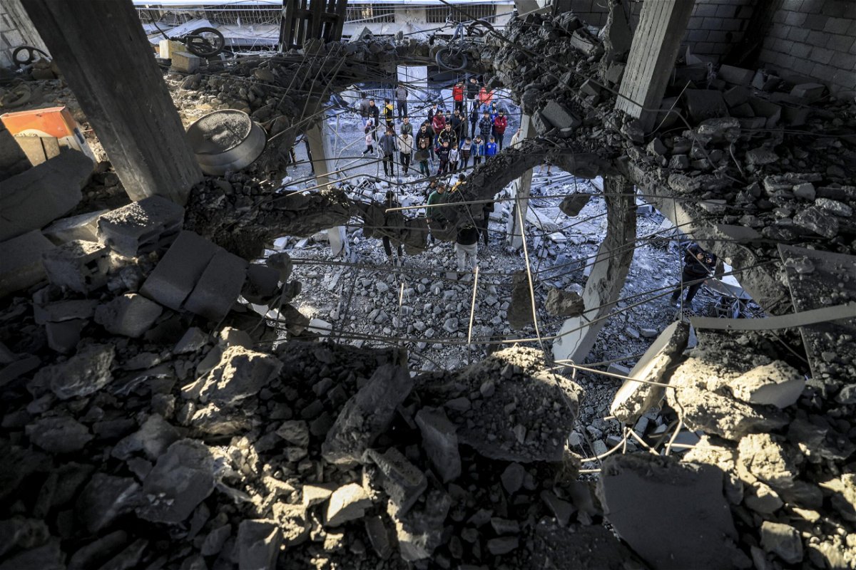 People inspect the rubble of a building where the displaced Palestinian Jabalieh family were sheltering after it was hit by apparent Israeli bombardment in Rafah, in the southern Gaza Strip on January 3.