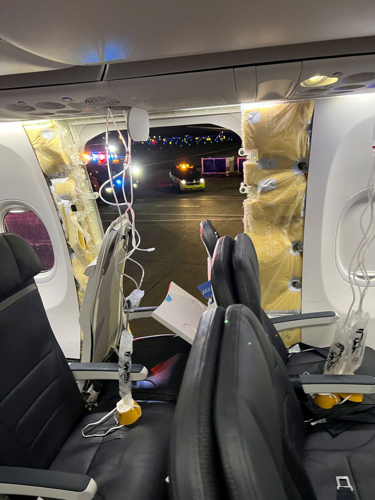 <i>@strawberrvy/Instagram/Reuters</i><br />Passenger oxygen masks hang from the roof next to a missing window and a portion of a side wall of an Alaska Airlines Flight 1282