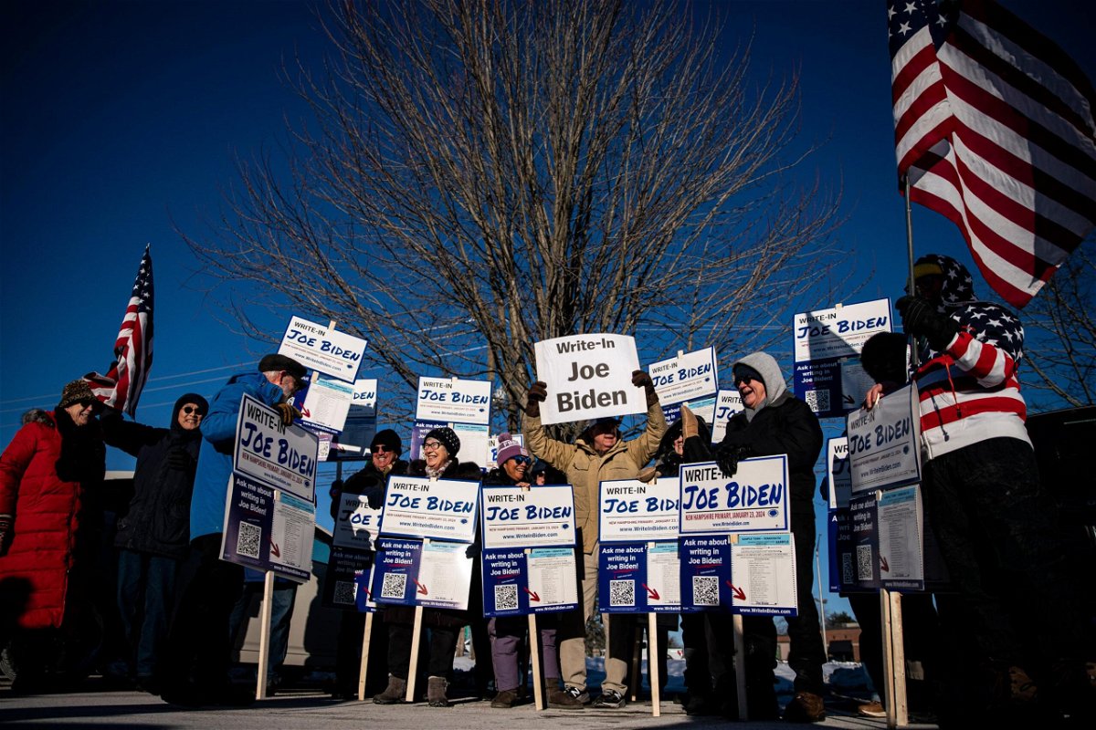 <i>Al Drago/Bloomberg/Getty Images</i><br/>Attendees hold signs during a Write-In Joe Biden campaign 