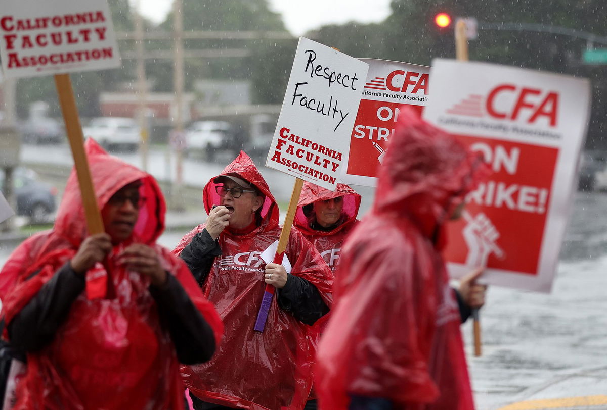 <i>Justin Sullivan/Getty Images</i><br/>Members of the Cal State University carry signs as they strike in front of San Francisco State University.