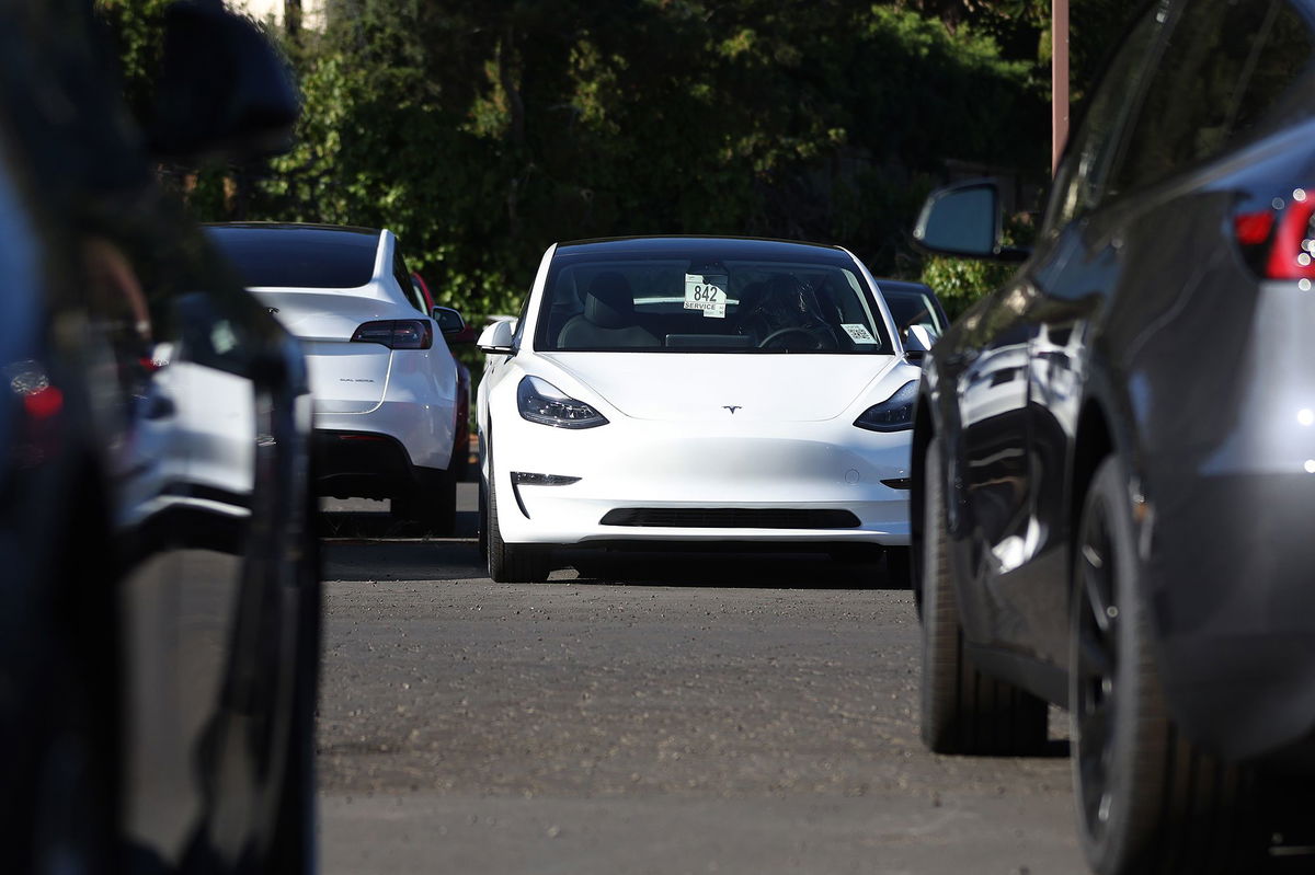 Brand new Tesla cars sit parked at a Tesla dealership on October 18, 2023 in Corte Madera, California.