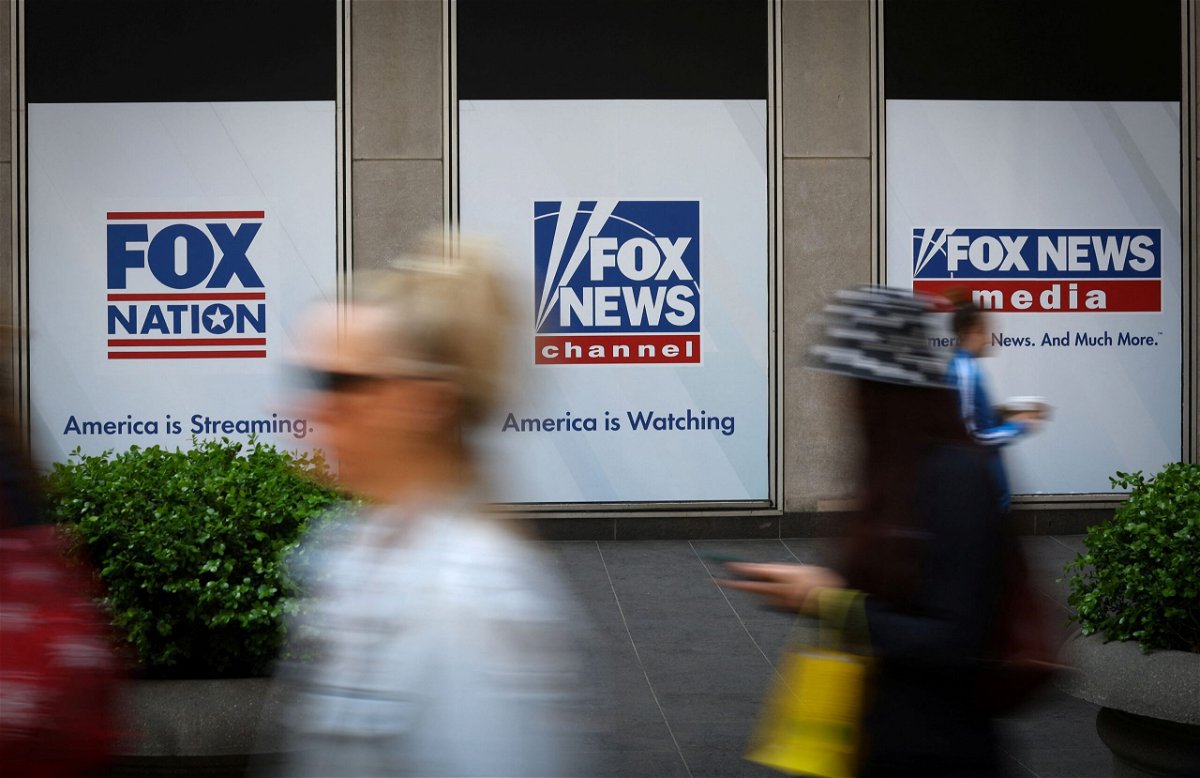 <i>Mike Segar/Reuters</i><br/>People walk past Fox News posters on the exterior of the Fox News headquarters building in New York City