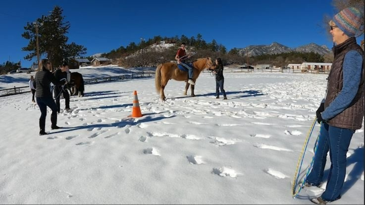 Remount Foundation volunteers assist with participant