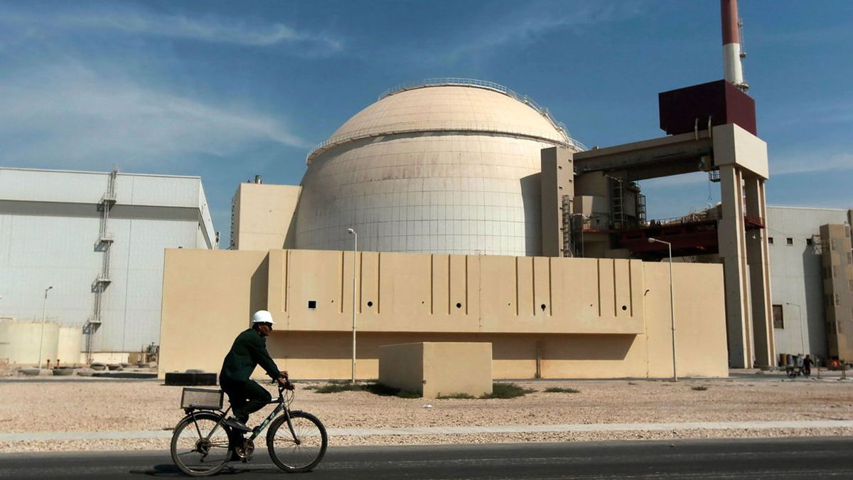 A worker rides past the reactor building of the Bushehr nuclear power plant, just outside the southern city of Bushehr, Iran, in 2010.
