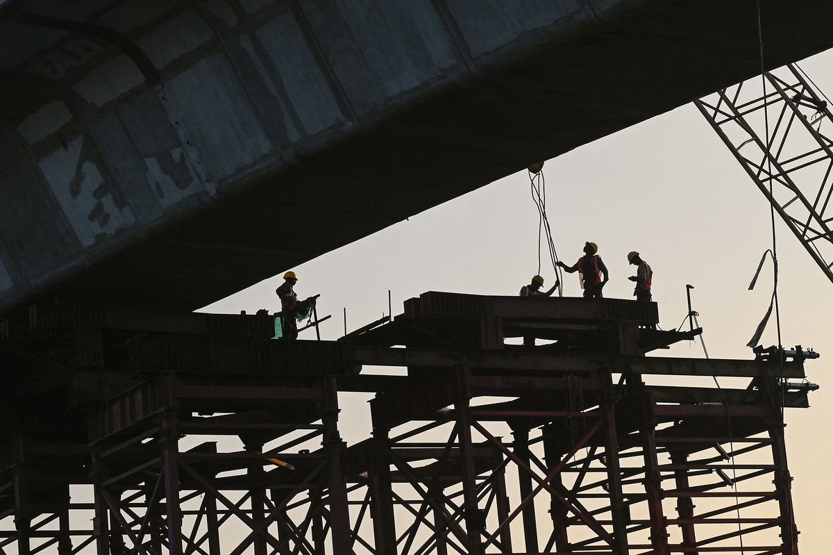 <i>Punit Paranjpe/AFP/Getty Images via CNN Newsource</i><br/>Laborers work at a construction site in Mumbai in November 2023.