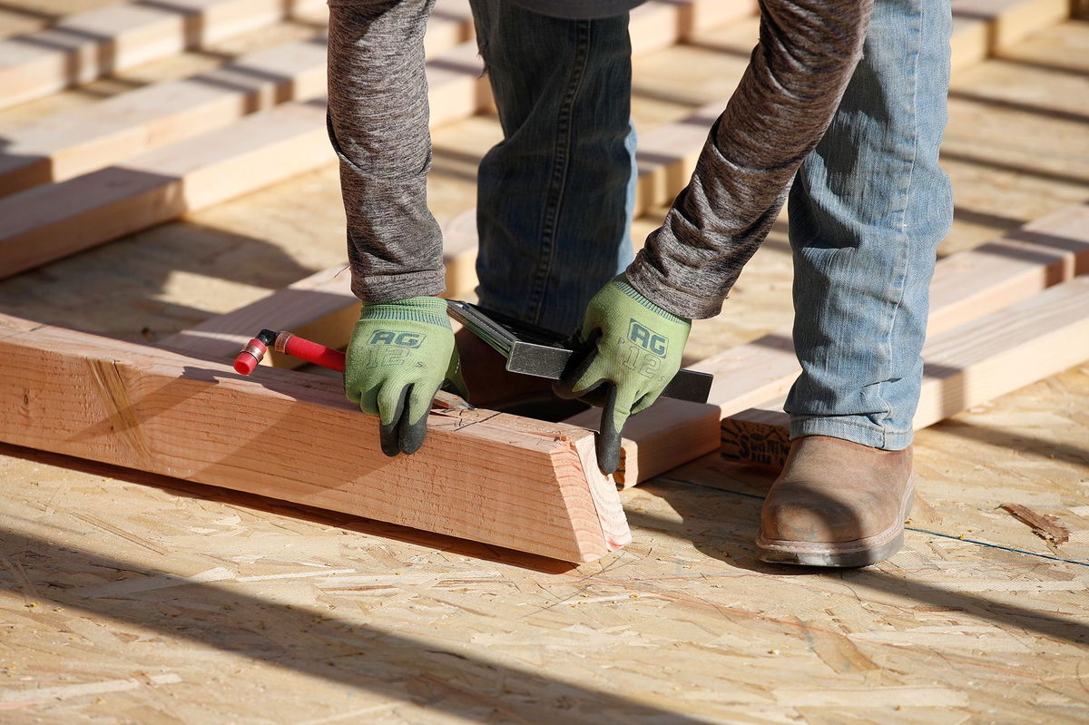 <i>George Frey/Bloomberg/Getty Images via CNN Newsource</i><br/>A contractor assembles a wall frame during the construction of a home in Utah in 2020.