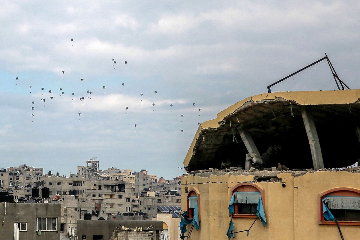 <i>AFP/Getty Images via CNN Newsource</i><br/>Aid parcels are airdropped over the northern Gaza Strip on Friday.