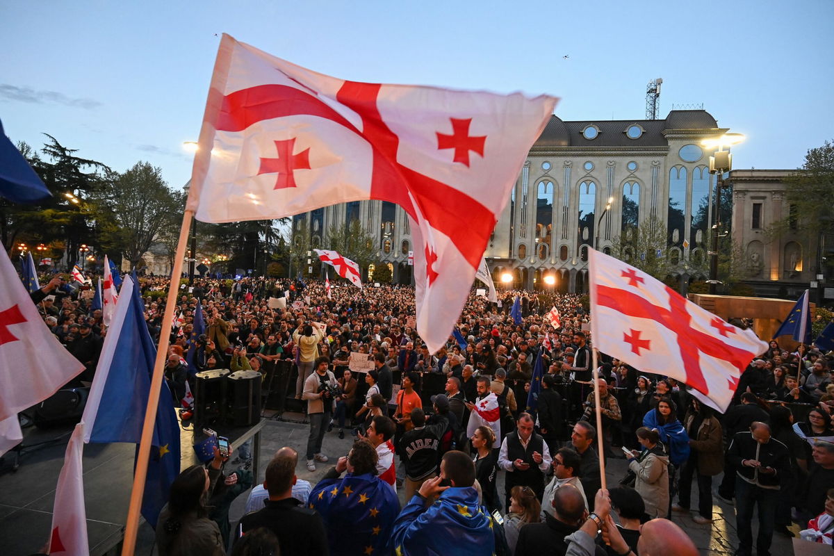 <i>Vano Shlamov/AFP/Getty Images via CNN Newsource</i><br/>Georgian pro-democracy activists wave Georgia and European Union flags as they protest against a 