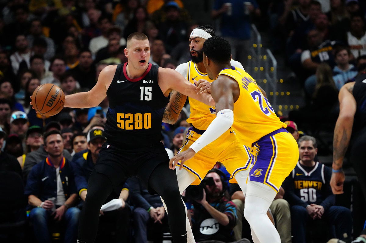 Nikola Jokić is defended by Los Angeles Lakers defenders Anthony Davis and Rui Hachimura during Game 2 of the Denver Nuggets' first round playoff series against the Lakers in the 2024 NBA Playoffs.