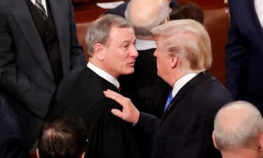 President Donald Trump speaks with Chief Justice John Roberts after delivering his State of the Union address in January 2018.
