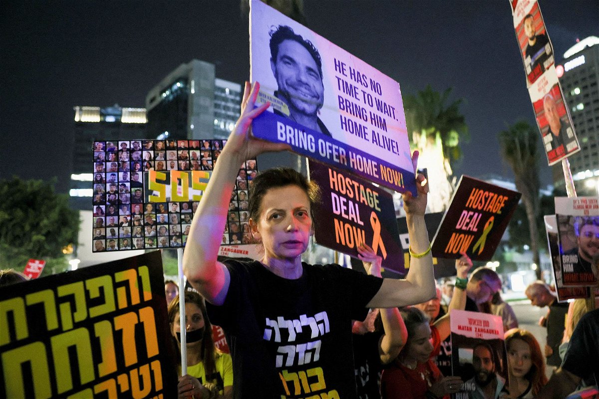 	Protesters hold posters calling for the immediate release of Israeli hostages held in Gaza, in Tel Aviv, Israel.
